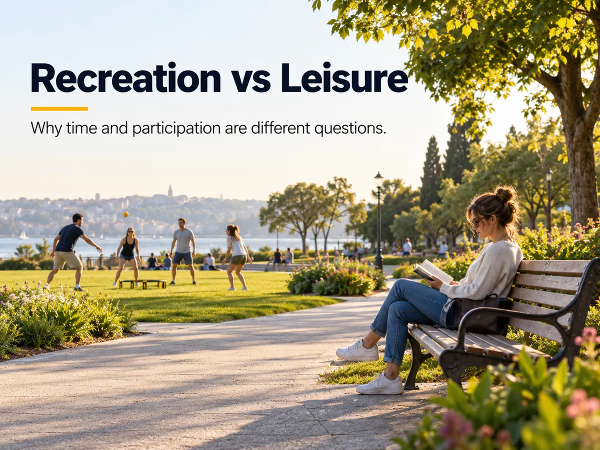 A woman reads on a park bench while four adults play a ball game on the nearby lawn.